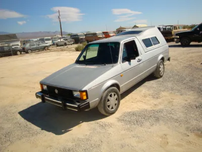 Silver VW Caddy with camper shell
