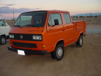 Red-orange VW T3 double-cab pickup