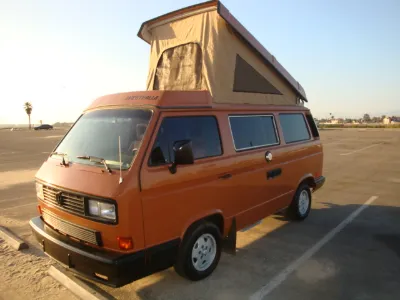 Orange VW Vanagon Westfalia with pop-top raised