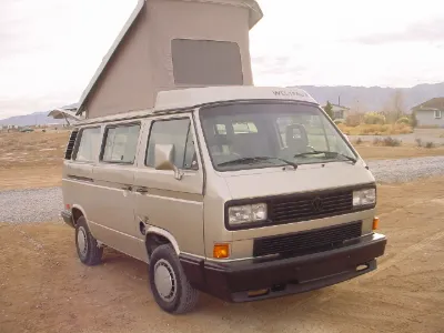 Beige VW Vanagon Westfalia with pop-top raised
