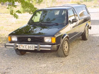 Black VW Caddy with camper shell