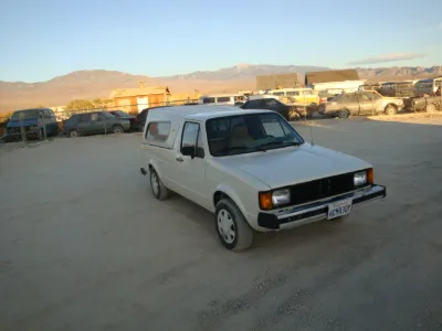 White VW Caddy with camper shell