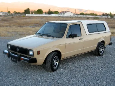 Beige VW Caddy with camper shell